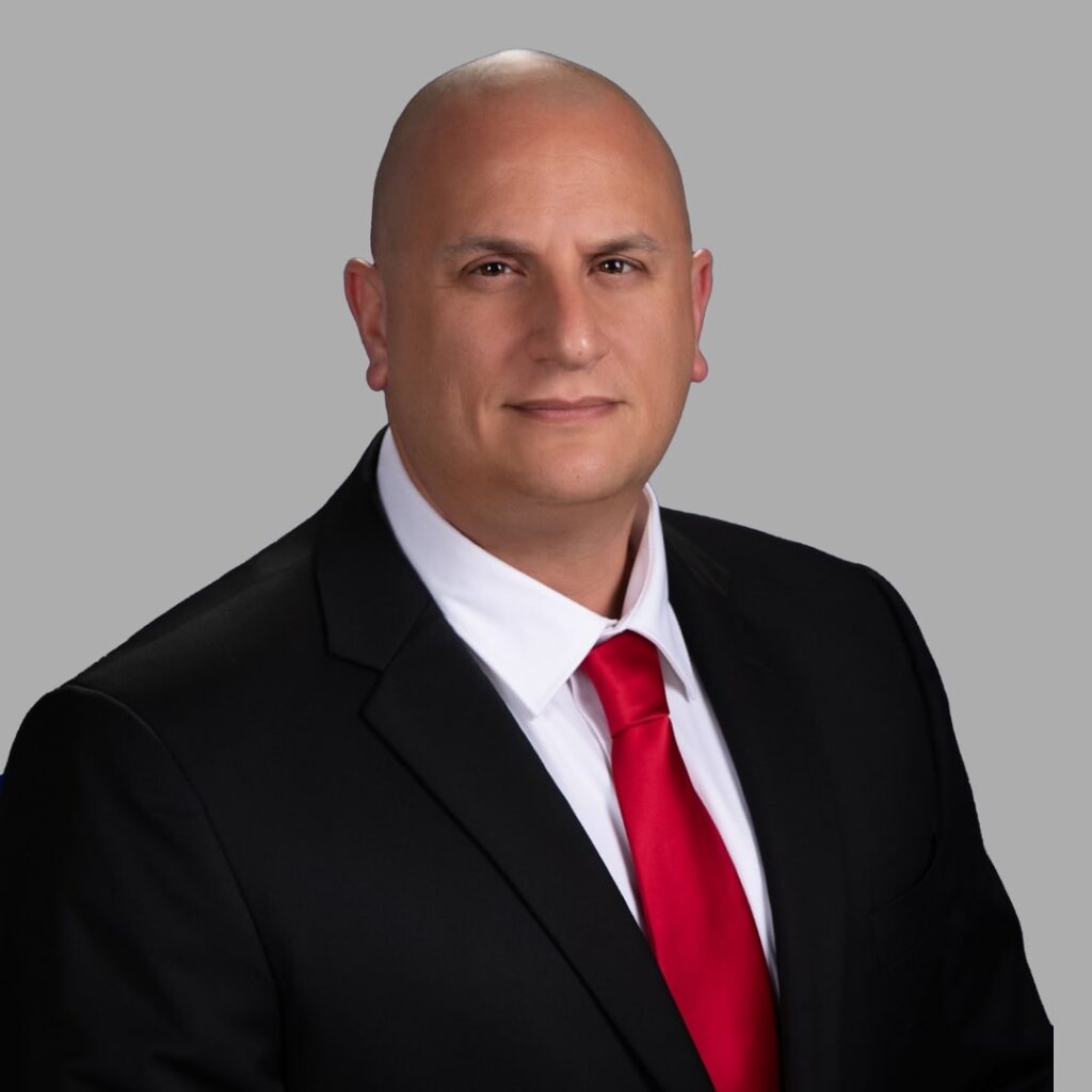 A headshot of a man in a suit