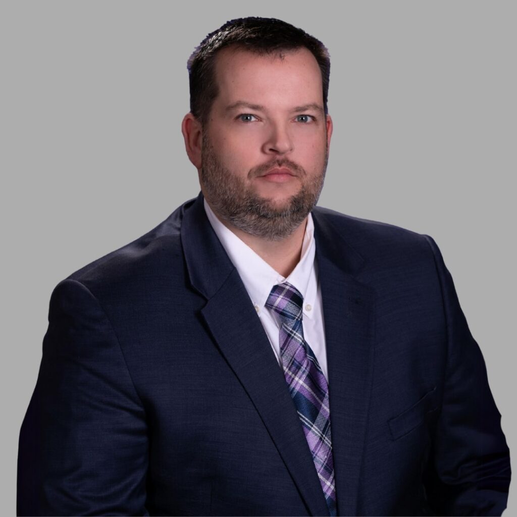 A headshot of a man in a suit